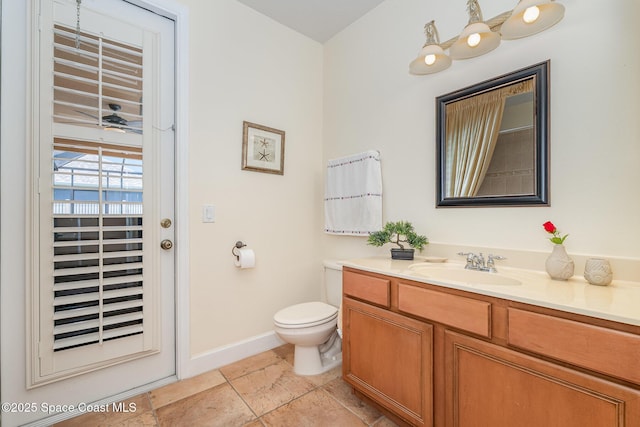 1472 Bent Palm Dr, Merritt Island, FL 32952 - bathroom featuring vanity, toilet, baseboards, and tile patterned flooring