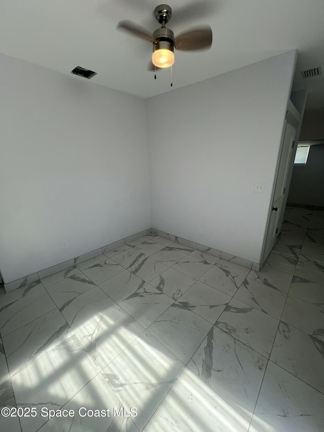1279 Earl Dr, Merritt Island, FL 32952 - spare room featuring baseboards, marble finish floor, ceiling fan, and visible vents