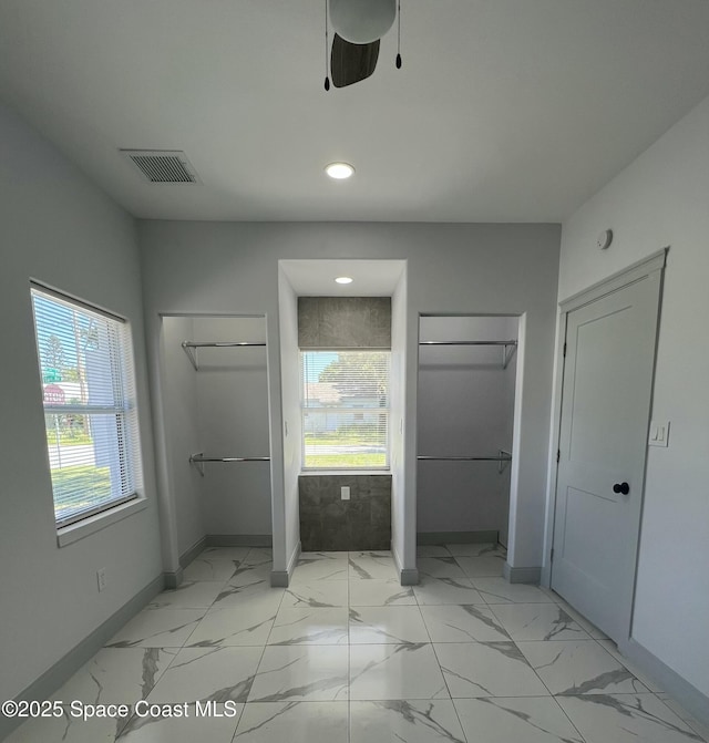 1279 Earl Dr, Merritt Island, FL 32952 - unfurnished bedroom with two closets, visible vents, recessed lighting, marble finish floor, and baseboards