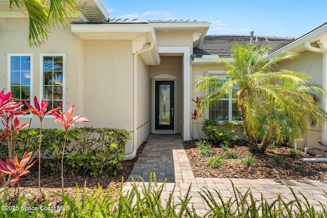 property entrance featuring stucco siding