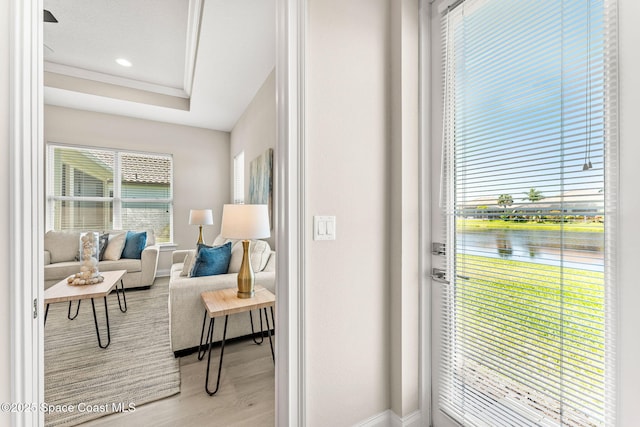 entryway featuring a water view, baseboards, recessed lighting, and wood finished floors