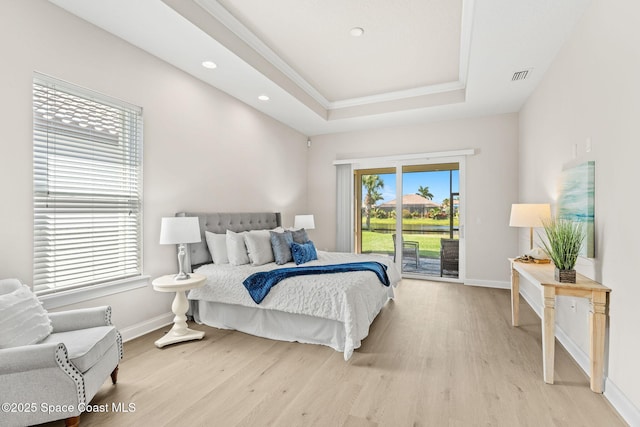 bedroom with access to outside, light wood finished floors, and baseboards