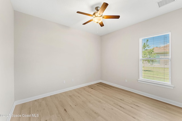 unfurnished room with a ceiling fan, baseboards, visible vents, and light wood finished floors