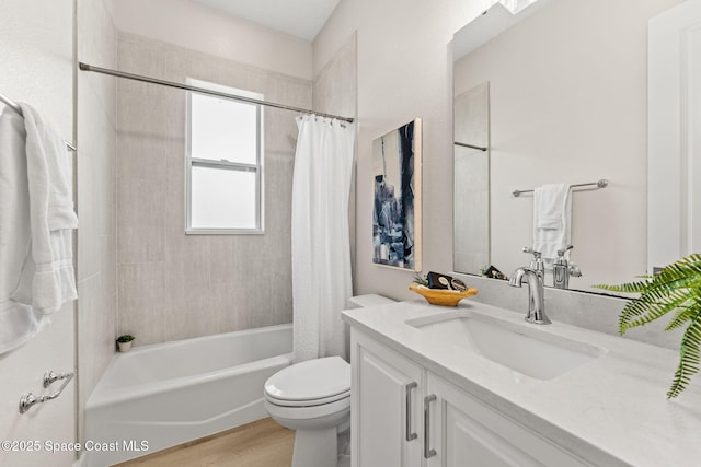 full bathroom featuring vanity, toilet, wood finished floors, and shower / tub combo with curtain