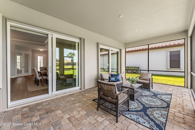 sunroom featuring an outdoor living space