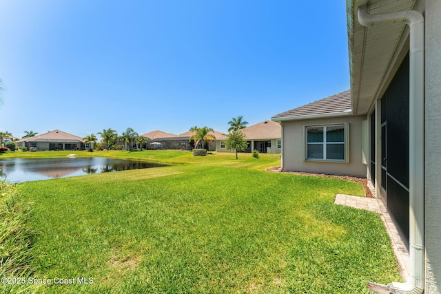 view of yard with a water view and a residential view
