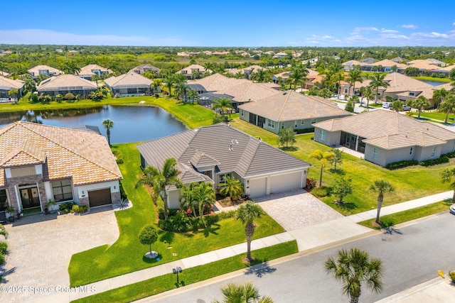 drone / aerial view with a water view and a residential view