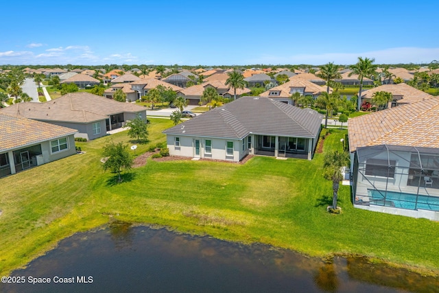 drone / aerial view with a water view and a residential view