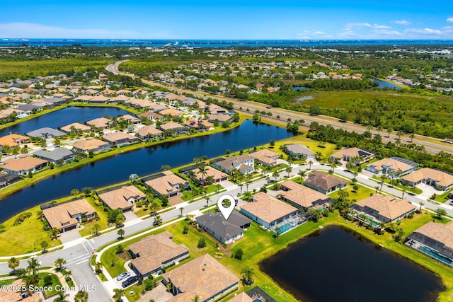 bird's eye view with a residential view and a water view