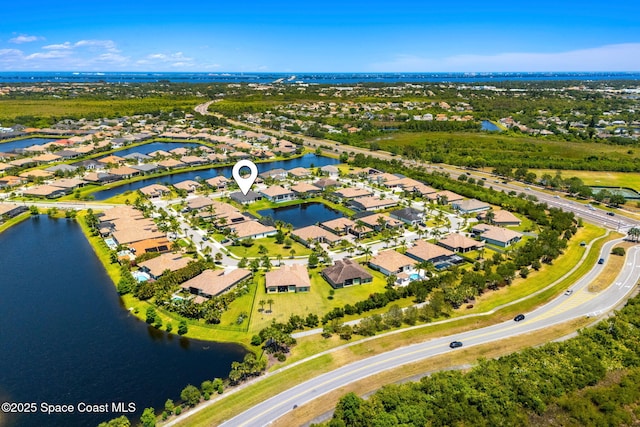birds eye view of property with a water view and a residential view