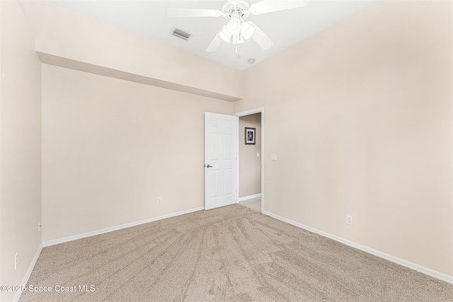 spare room featuring baseboards, visible vents, ceiling fan, and carpet floors