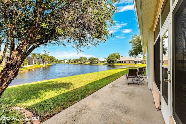 view of patio with a residential view and a water view