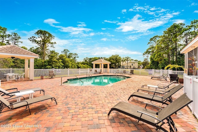 pool with a patio, a gazebo, and fence