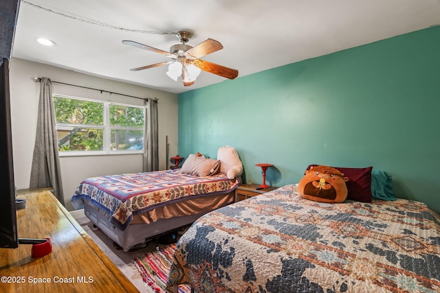 bedroom with a ceiling fan, wood finished floors, and recessed lighting