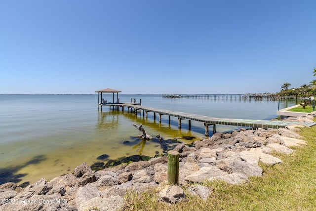 view of dock featuring boat lift and a water view