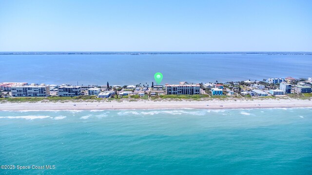 drone / aerial view with a beach view and a water view