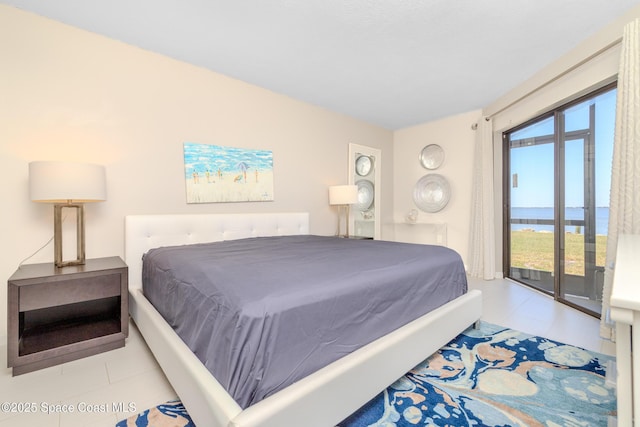 tiled bedroom featuring a water view and access to exterior