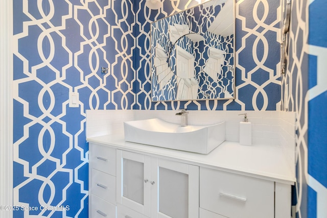 bathroom featuring vanity and tasteful backsplash