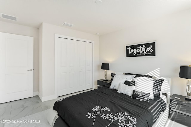 bedroom featuring a closet, marble finish floor, baseboards, and visible vents