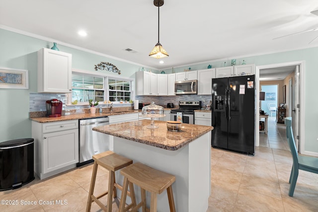 kitchen featuring light stone counters, light tile patterned floors, backsplash, and stainless steel appliances