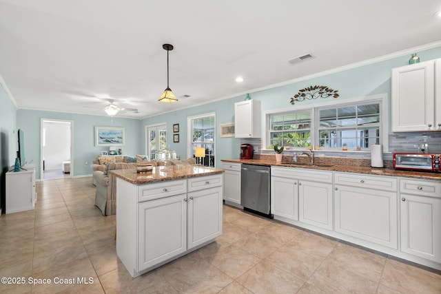 kitchen featuring visible vents, crown molding, dishwasher, a sink, and stone countertops
