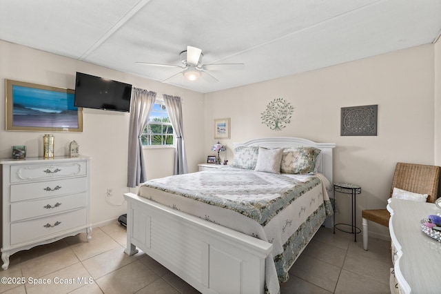 bedroom featuring baseboards, ceiling fan, and light tile patterned floors