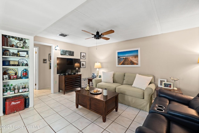 living room featuring ceiling fan, light tile patterned flooring, and visible vents