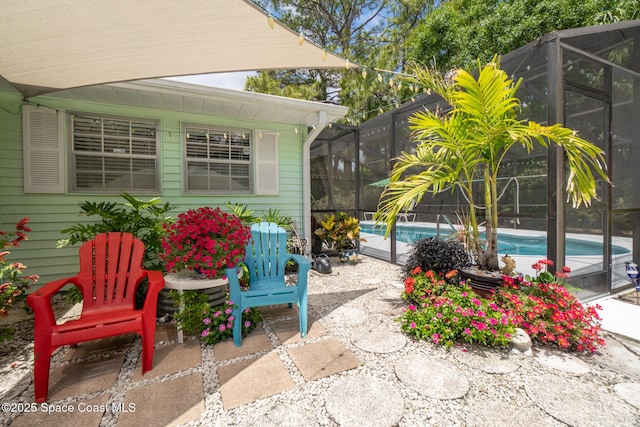 view of patio / terrace with an outdoor pool and a lanai