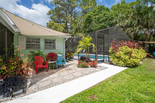 view of yard featuring glass enclosure, a patio area, and an outdoor pool