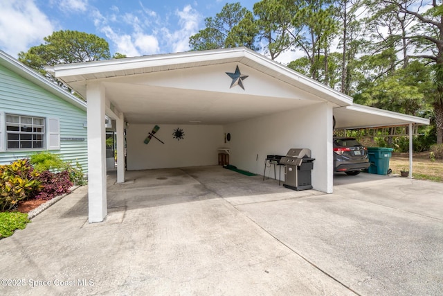 view of parking with driveway and a carport