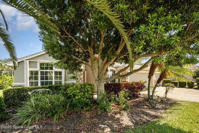 3196 Quint Dr, Melbourne, FL 32940 - view of property exterior with decorative driveway, stucco siding, and an attached garage