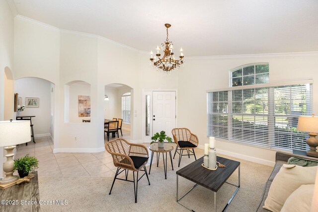 3196 Quint Dr, Melbourne, FL 32940 - living area featuring arched walkways, crown molding, a chandelier, healthy amount of natural light, and baseboards