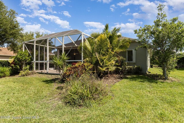 3196 Quint Dr, Melbourne, FL 32940 - back of house featuring a yard and glass enclosure