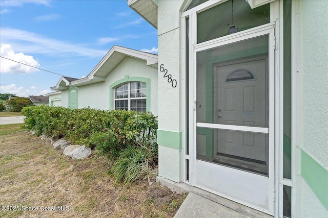 6280 Golfview Ave, Cocoa, FL 32927 - doorway to property featuring stucco siding