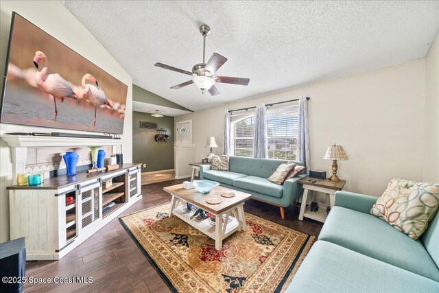 6280 Golfview Ave, Cocoa, FL 32927 - living room featuring dark wood-style flooring, a textured ceiling, a ceiling fan, baseboards, and lofted ceiling