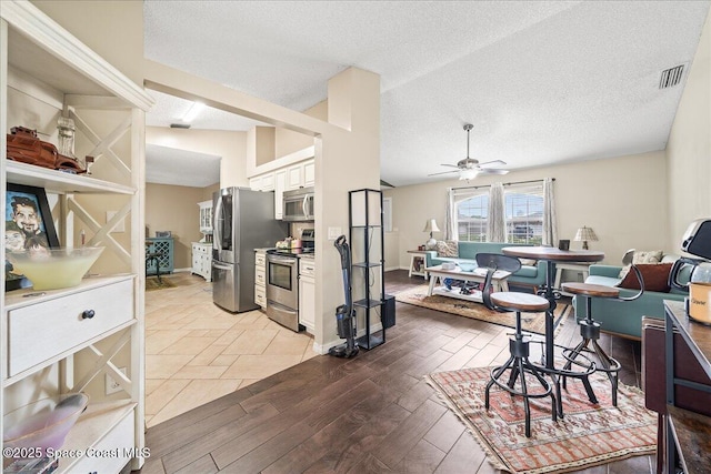 6280 Golfview Ave, Cocoa, FL 32927 - interior space with light wood-style flooring, a ceiling fan, a textured ceiling, and visible vents