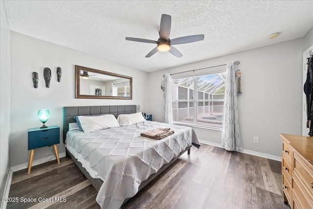 6280 Golfview Ave, Cocoa, FL 32927 - bedroom featuring baseboards, a textured ceiling, ceiling fan, and wood finished floors