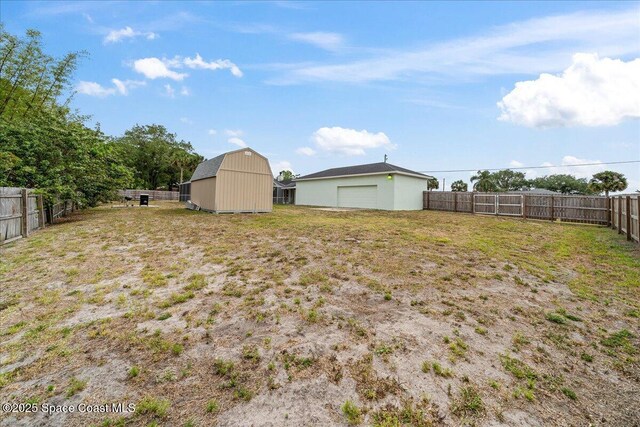 6280 Golfview Ave, Cocoa, FL 32927 - view of yard with a fenced backyard, a detached garage, an outbuilding, and a barn