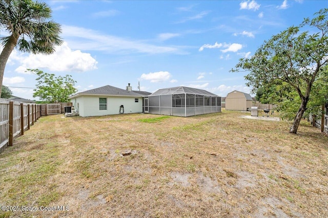 6280 Golfview Ave, Cocoa, FL 32927 - view of yard featuring a fenced backyard, an outbuilding, a lanai, and a shed
