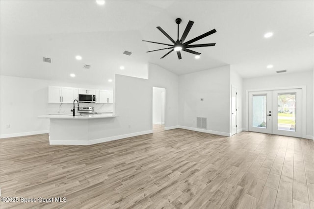 3871 La Flor Dr, Rockledge, FL 32955 - unfurnished living room with lofted ceiling, visible vents, and recessed lighting