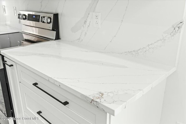 3871 La Flor Dr, Rockledge, FL 32955 - interior details featuring electric range, white cabinets, and light stone counters