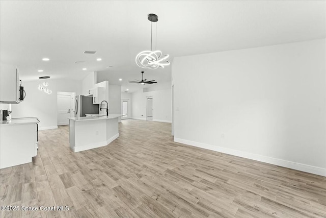 3871 La Flor Dr, Rockledge, FL 32955 - kitchen with open floor plan, light wood-style flooring, freestanding refrigerator, and recessed lighting