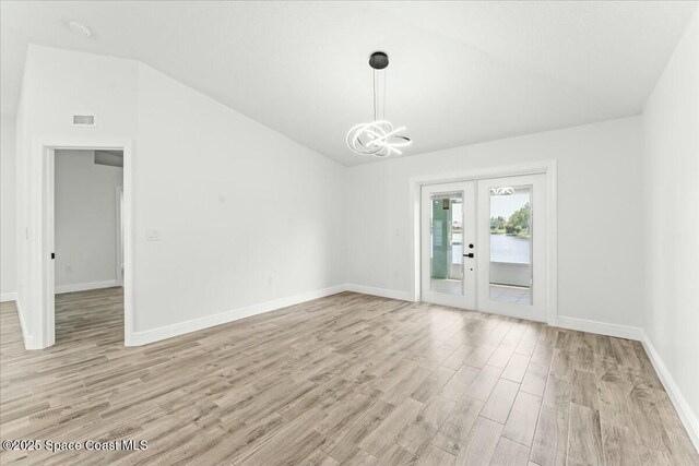 3871 La Flor Dr, Rockledge, FL 32955 - interior space featuring light wood-style floors, french doors, baseboards, lofted ceiling, and visible vents