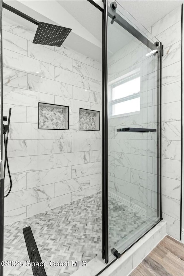 3871 La Flor Dr, Rockledge, FL 32955 - bathroom with a shower stall and wood finished floors