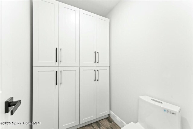 3871 La Flor Dr, Rockledge, FL 32955 - bathroom with wood finished floors, toilet, and baseboards