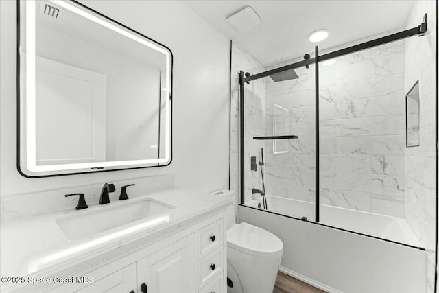 3871 La Flor Dr, Rockledge, FL 32955 - bathroom featuring wood finished floors, vanity, enclosed tub / shower combo, and toilet