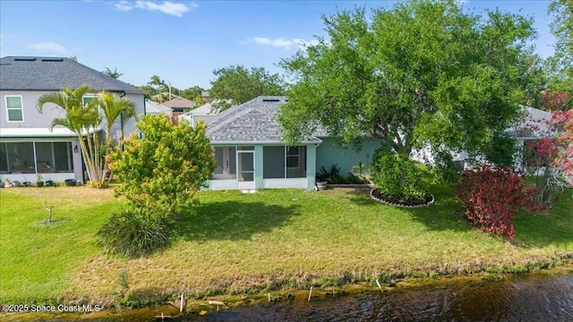 3871 La Flor Dr, Rockledge, FL 32955 - back of house with a sunroom, a water view, and a yard