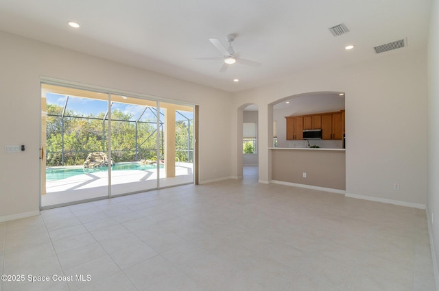 5334 Creekwood Dr, Melbourne, FL 32940 - unfurnished living room featuring a healthy amount of sunlight, a ceiling fan, and visible vents