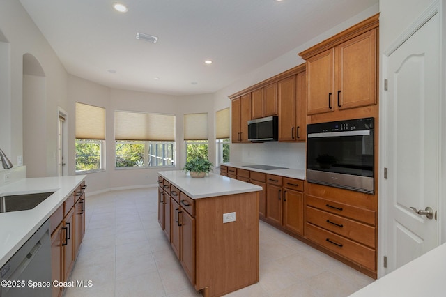 5334 Creekwood Dr, Melbourne, FL 32940 - kitchen featuring white dishwasher, a sink, wall oven, stainless steel microwave, and black electric stovetop