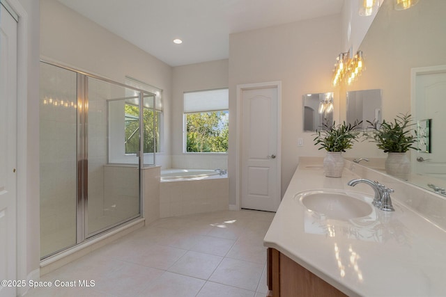 5334 Creekwood Dr, Melbourne, FL 32940 - bathroom featuring double vanity, tile patterned floors, a shower stall, a bath, and a sink